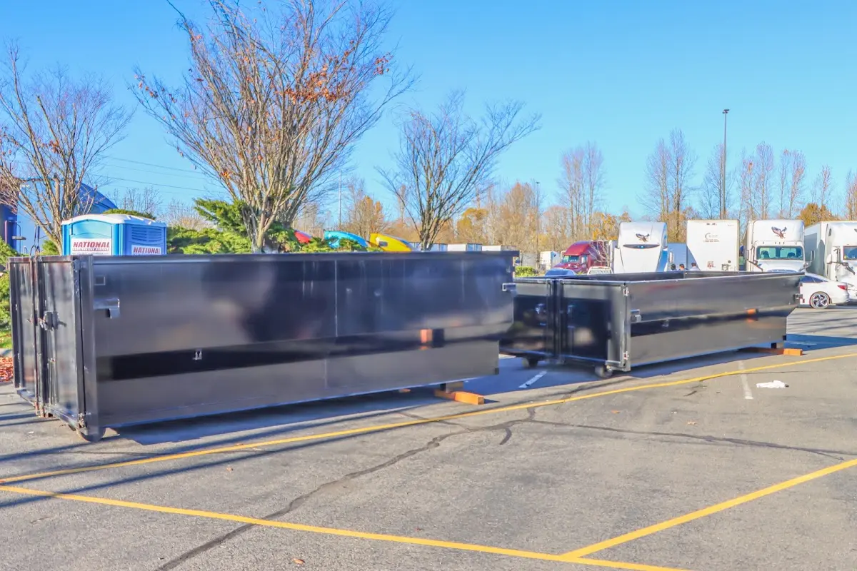 Professional dumpster rental service with roll-off container on residential driveway in Weldon Spring